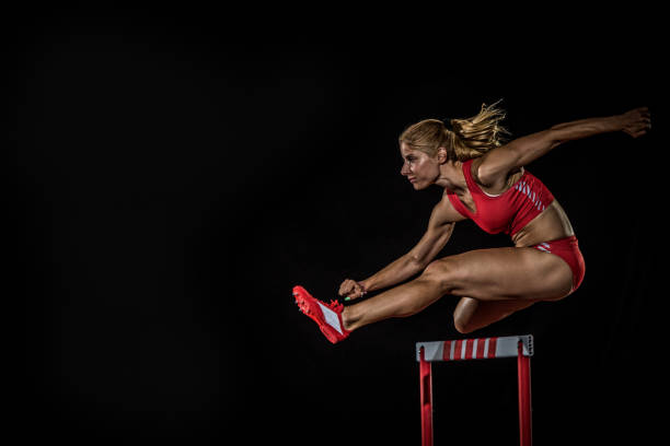 istock Female caucasian athlete hurdling 1269858249