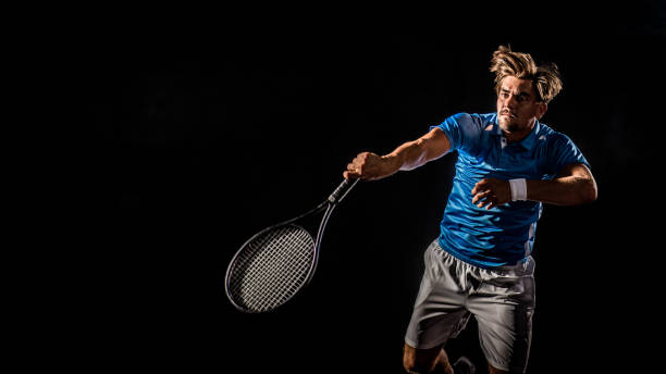 istock Caucasian tennis player in mid swing 1269858288