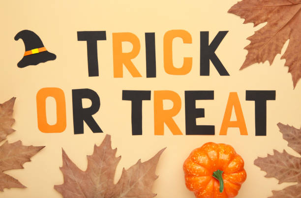 istock Trick or treat background with autumn leaves on beige 1269859982