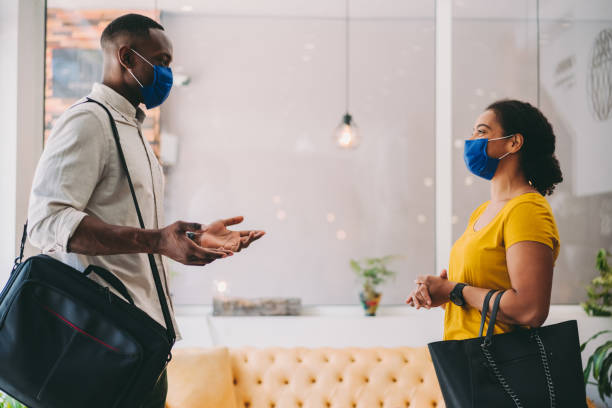 istock Business people wearing protective face masks at work 1269864216