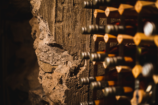 A wine cave with wine bottle with old brick wall