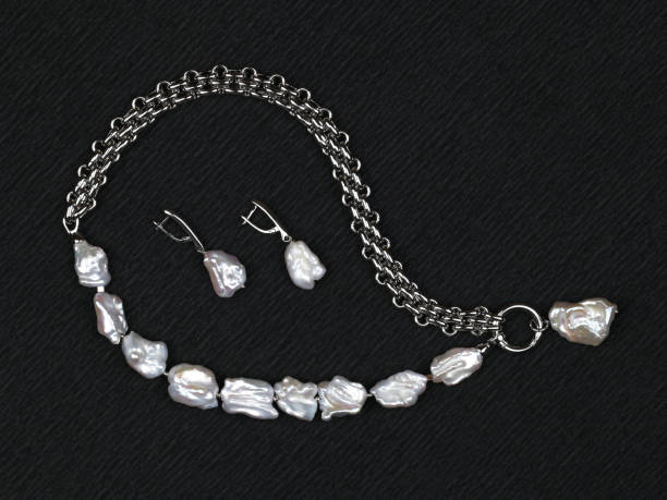 istock Set of baroque pearls on black textured background 1269867892