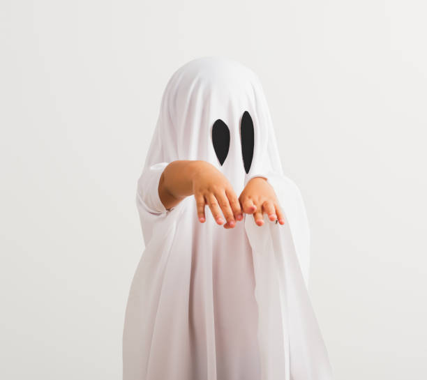 istock little cute child with white dressed costume halloween ghost scary 1269868423
