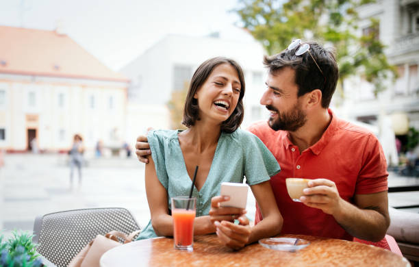 istock Cheerful young couple on a romantic date in a cafe. 1269872847