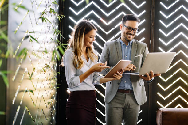 istock Cheerful coworkers in office working and brainstorming together 1269874943