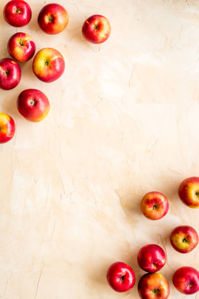 istock Fruit pattern of red apples on table desk top view 1269875362