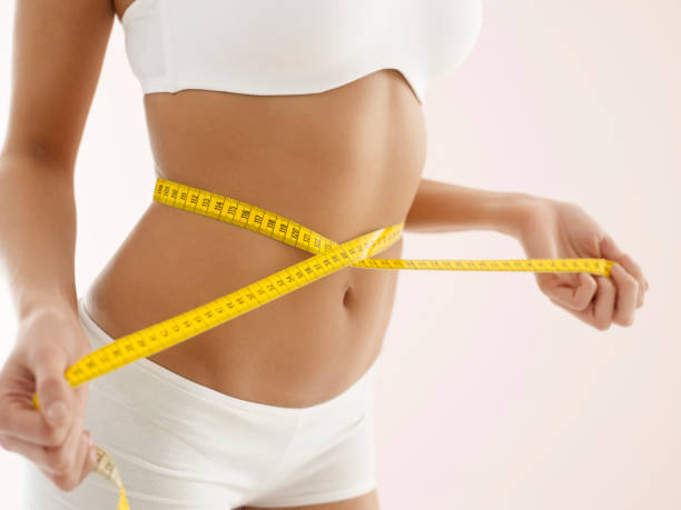 istock Fit woman with measuring tape 1269876999