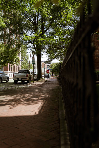 istock Morning walk in Freemason District (historical neighborhood) brick sidewalk decorative wrought iron gates 1269878589