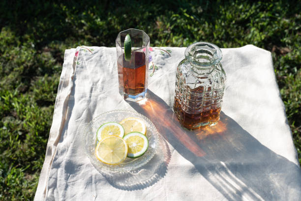 istock Refreshing ice tea with lime slice in the garden at sunset 1269878820