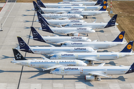 Berlin, Germany - August 19, 2020: Stored Lufthansa airplanes Coronavirus Corona Virus COVID-19 Berlin Brandenburg BER airport aerial view photo in Germany.