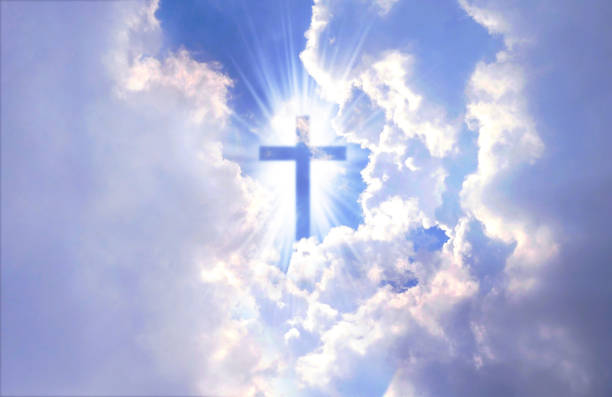 istock Christian cross appears bright in the sky 1269878945