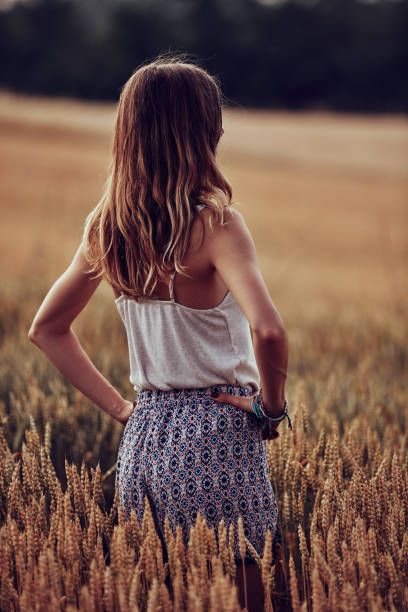istock Young woman enjoying in a wheat field. 1269879055