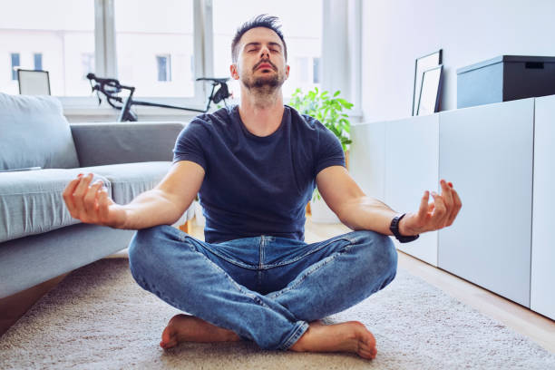 istock Young man meditating at home 1269882546