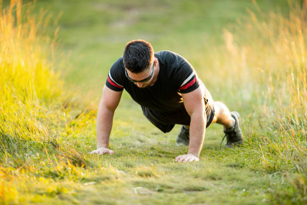istock A young handsome man trains in nature 1269882596