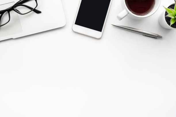 istock White office desk table with laptop computer, smartphone with blank screen and lot of things on it. Top view with copy space, flat lay. 1269882610