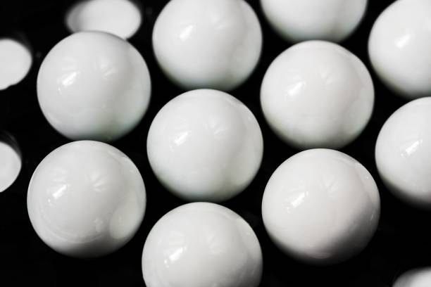 istock Group of white spheres on black background, closeup. 1269883979