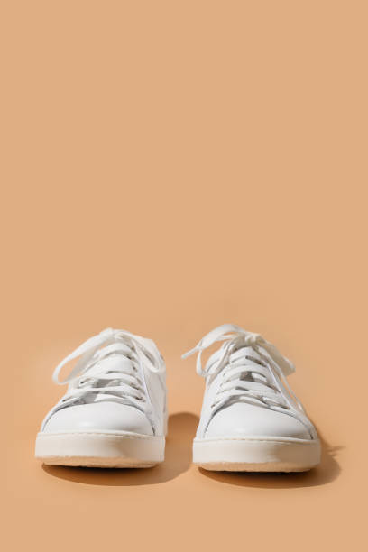 istock White female gumshoes on beige background. 1269893947