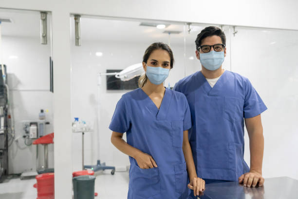 Veterinary surgeons at the operating room wearing facemasks Portrait of veterinary surgeons at the operating room wearing facemasks and looking at the camera during the COVId-19 pandemic operating room photos stock pictures, royalty-free photos & images