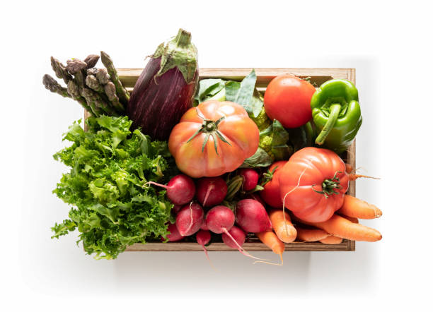 istock Wooden box with fresh vegetables, isolated from the white background. top view 1269894404