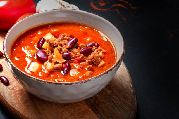 istock Chili con carne in a bowl on a black background 1269895633