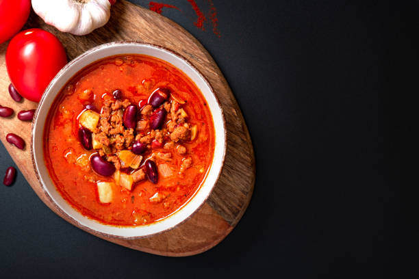 istock Chili con carne in a bowl on a black background 1269895639
