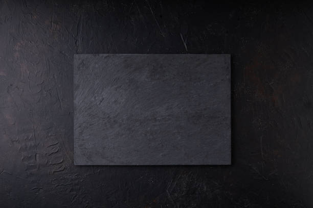 istock Black stone tray on a black background Copy space Dark photo Mock up 1269896701