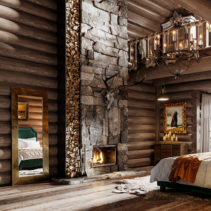 Interior decoration of log cabin bedroom. Big mirror by the fireplace with artifacts in winter cottage bedroom.