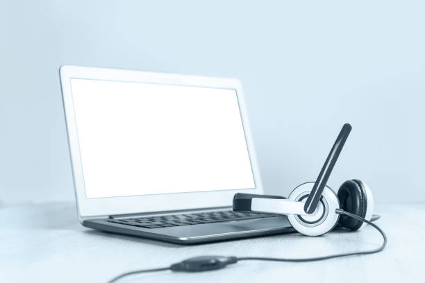 istock Laptop with headphones on white desk 1269897090