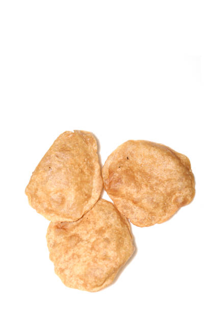 istock Puffed fried puri isolated on a white background isolated on a white background 1269898171