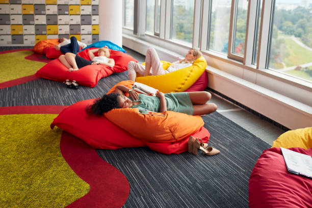 Diverse people in modern office power napping during lunch break