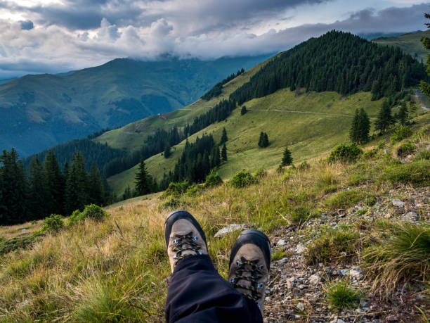 One man's boots in frond of camera, concept  mountain scene.