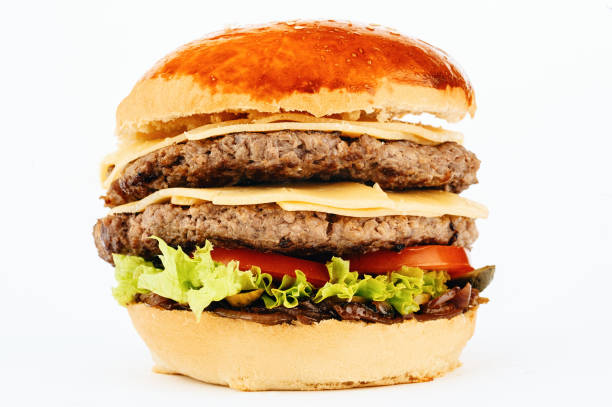 istock Hamburger sandwich with two beef cutlets, cheddar cheese slices, green salad leaves and fried onion 1269899992