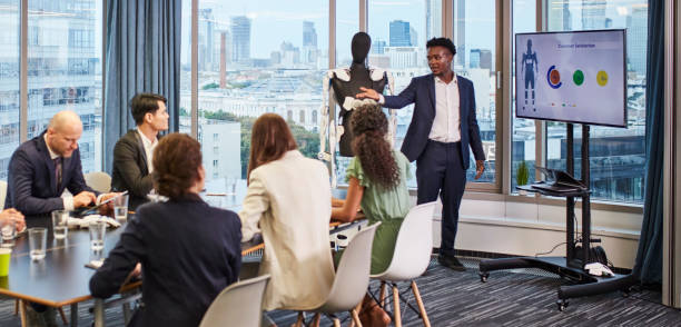 istock Startup meeting. African businessman presenting exoskeleton prototype 1269900278