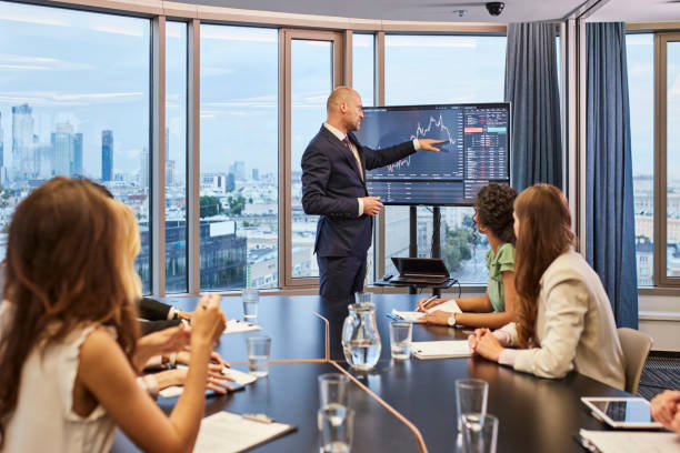 istock Business meeting: analyzing post pandemic stock market. Multi ethnic team in board room 1269900326