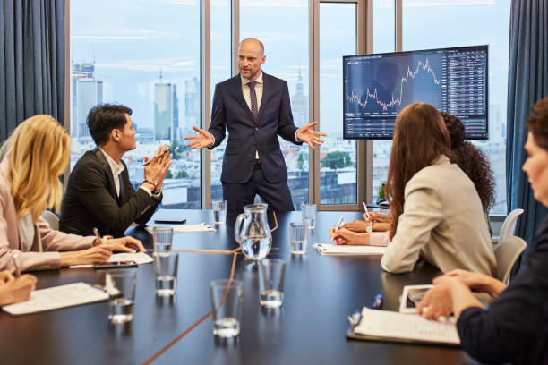 Business meeting: analyzing post pandemic stock market. Multi ethnic team in board room