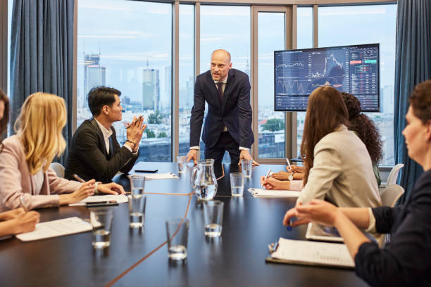 istock Business meeting: analyzing post pandemic stock market. Multi ethnic team in board room 1269900351