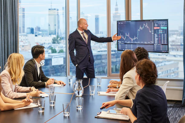 istock Business meeting: analyzing post pandemic stock market. Multi ethnic team in board room 1269900352