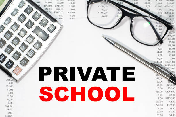 istock Business concept. Notebook with text PRIVATE SCHOOL sheet of white paper for notes, calculator, glasses, pencil, pen, in the white background 1269900357