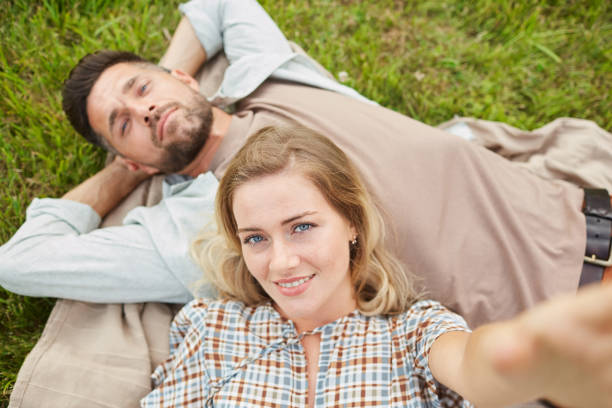 istock Couple Taking Selfie in Park POV 1269900853