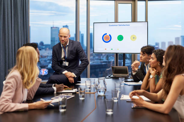 istock Business meeting: analyzing post pandemic stock market. Multi ethnic team in board room 1269902424