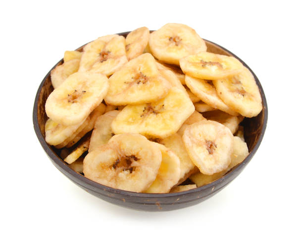 istock Banana chips in wood bowl on white background 1269904752