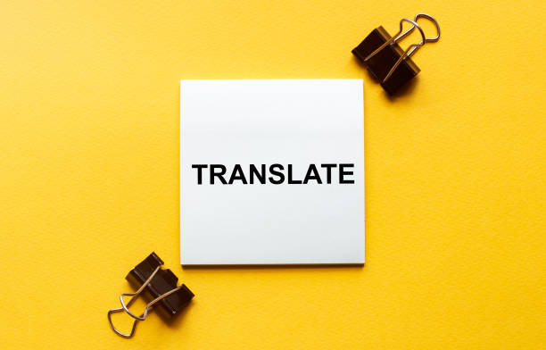 istock white paper with text Translate on a yellow background with stationery 1269905861