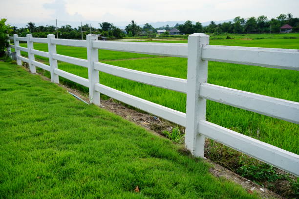 Free Stock Photo of Grassy Field With Wooden Fence and Buildings ...