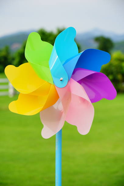 istock Rainbow Colorful Pinwheel on green background 1269908134