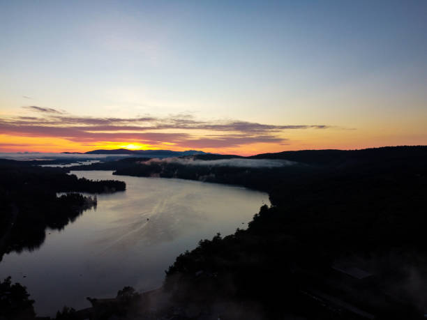 Sunrise over Lake Squam and mountain range in New Hampshire stock photo