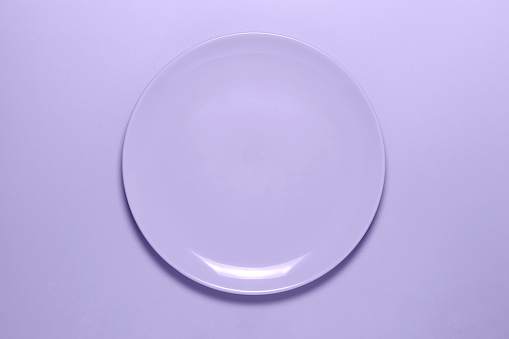 empty dish on matching color surface, top view