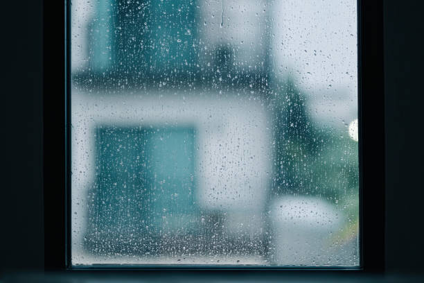 istock rain drops during raining in rainy day outside window glass with blurred background with water droplet flow down the surface 1269913084