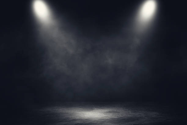 istock Studio dark room concrete floor grunge texture background with spotlight and white smoke. 1269914388