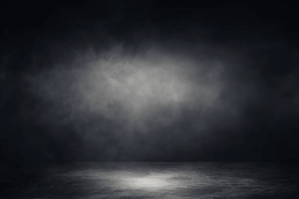 istock Studio dark room concrete floor grunge texture background with spotlight and white smoke. 1269914427