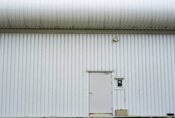Security Camera on corrugated iron building wall.